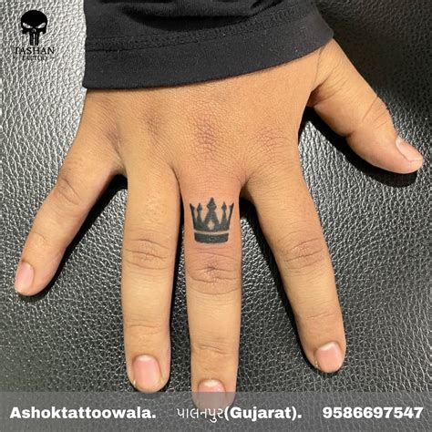 crown finger tattoo